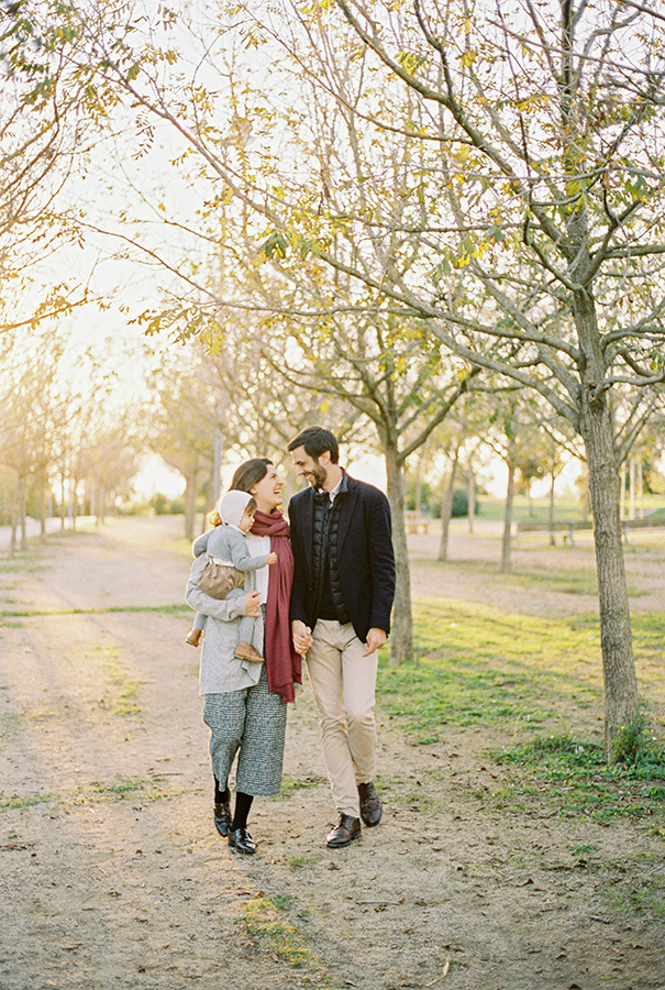 family with baby walking in the beautiful park during golden hour - family photographer barcelona