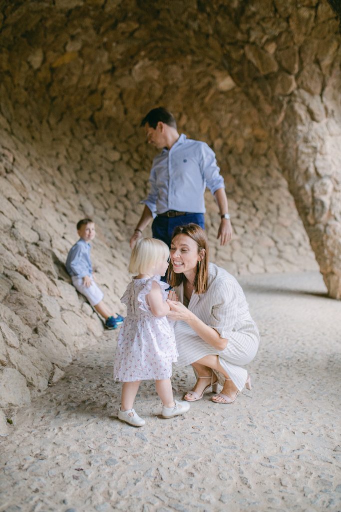 Mother playfully talking with her toddler dauther in Park Guell at vacation Barcelona Family Photographer