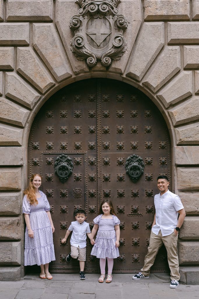 Family of four walking and having fun during Githic Quarter Family Photography with Lena Karelova