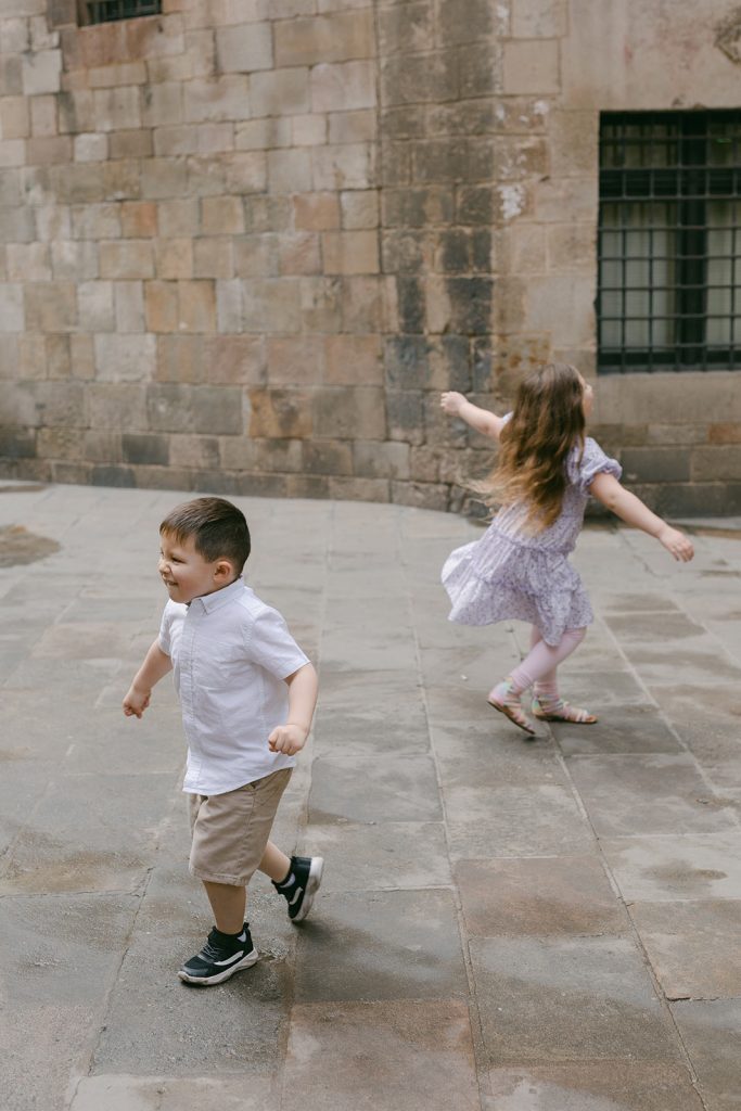 Sister and brother runing and having fun during the Gothic Quarter Family Photography