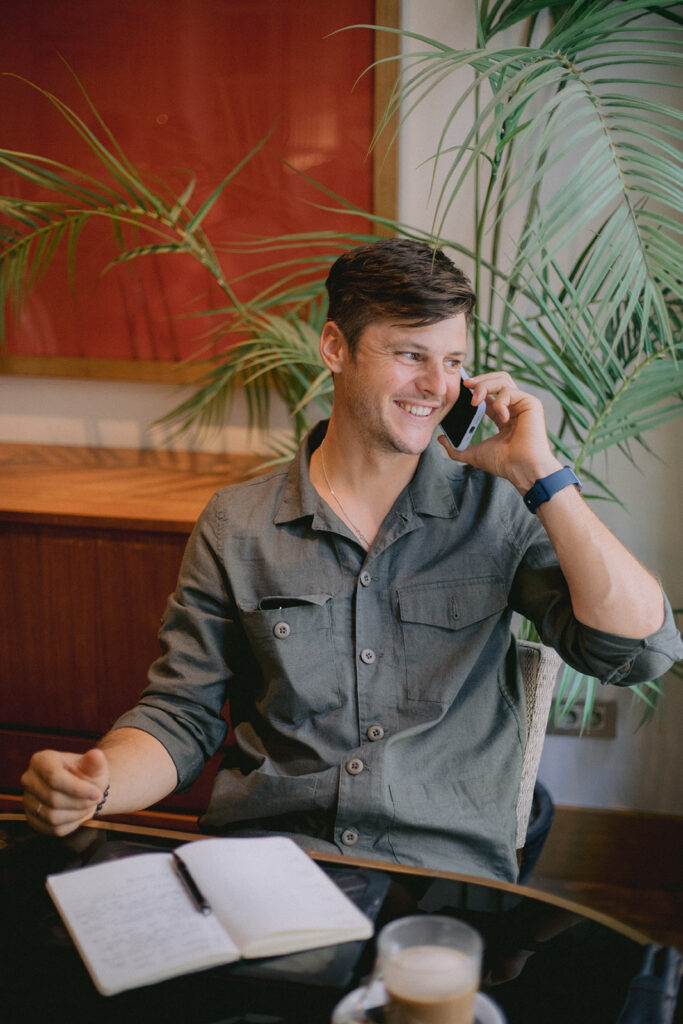 man having conversation on the phone while working in the luxury hotel