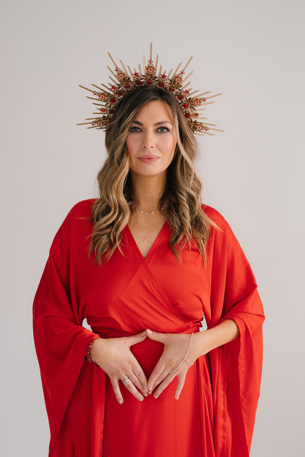 woman wearing red tunica with amazing crown a spiritual coach for women and kundalini facilitator