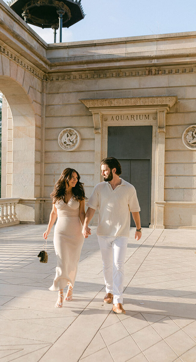 Walking young couple after surprise mariage proposal in Barcelona at Ciutadella Park