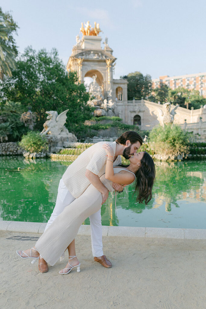 Kissing couple at Ciutadella Park on background during surprise proposal photoshoot in Barcelona