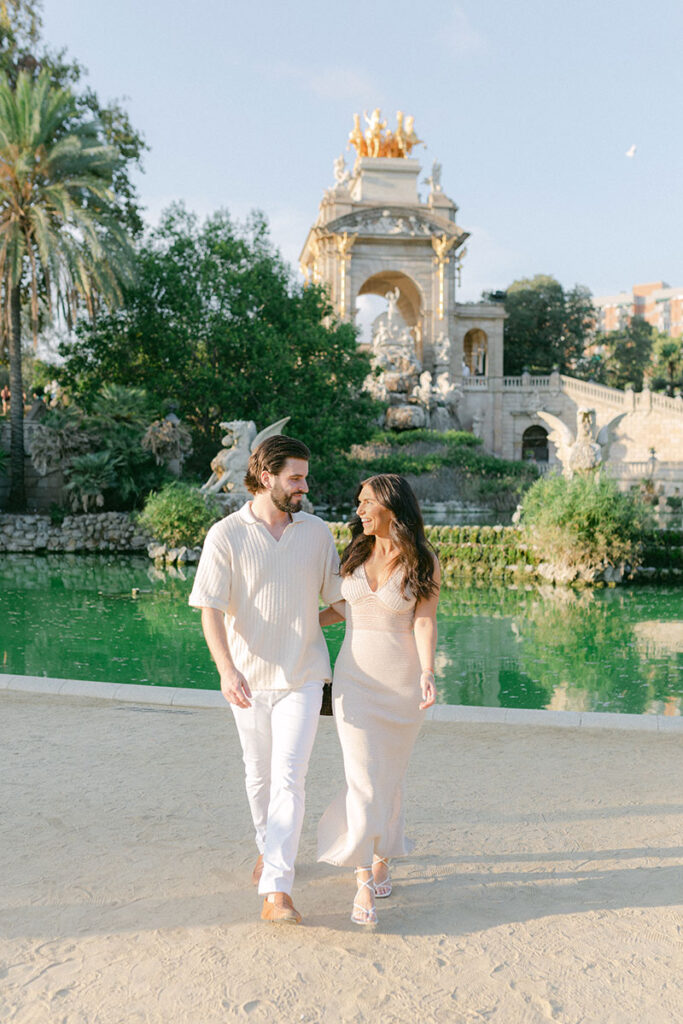 Happy young and stylish couple walking at Ciutadella Park aftyer surprise proposal in BArcelona