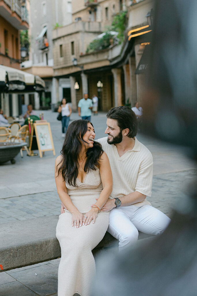 Young stylish couple having fun and laughing on the streets of El Borne after the surprise proposal in Barcelona
