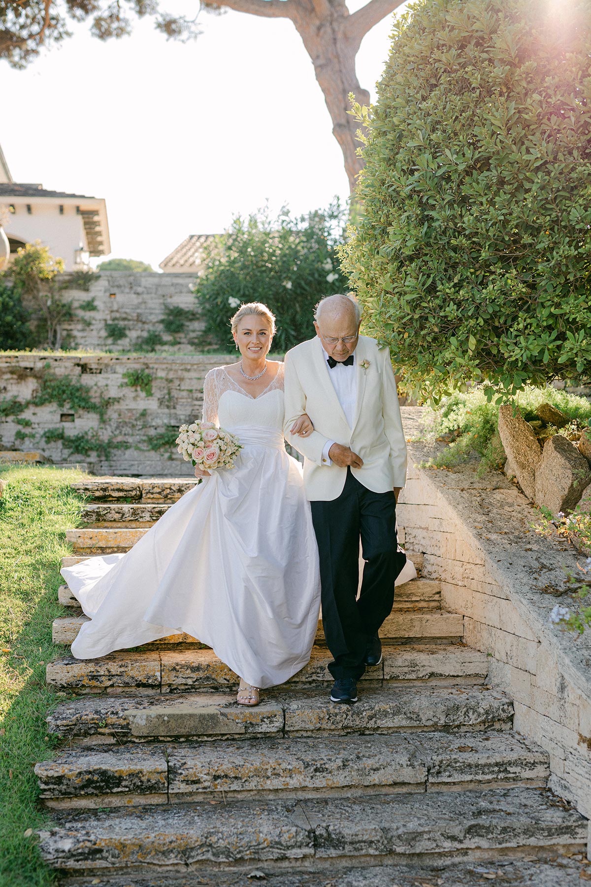 Bride walking through the aisle at her mediterranean wedding at Luxury Hotel in Spain - Lena Karelova Photography