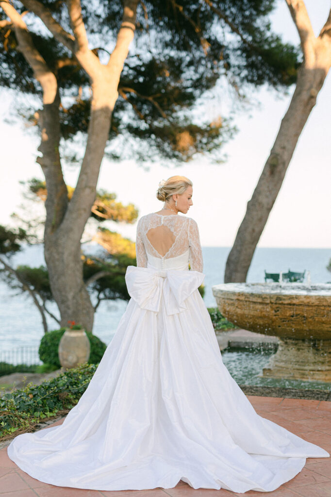 Bride standing at the gorgeous mediterranean villa wearing Santos Costura gown - Elegant mediterranean wedding in spain - Lena Karelova Photography