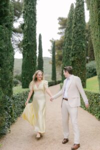 Romantic garden path lined with tall cypress trees and a sculpture at Santa Clotilde Gardens, ideal for engagement or elopement photography. Captured by an experienced Barcelona engagement photographer