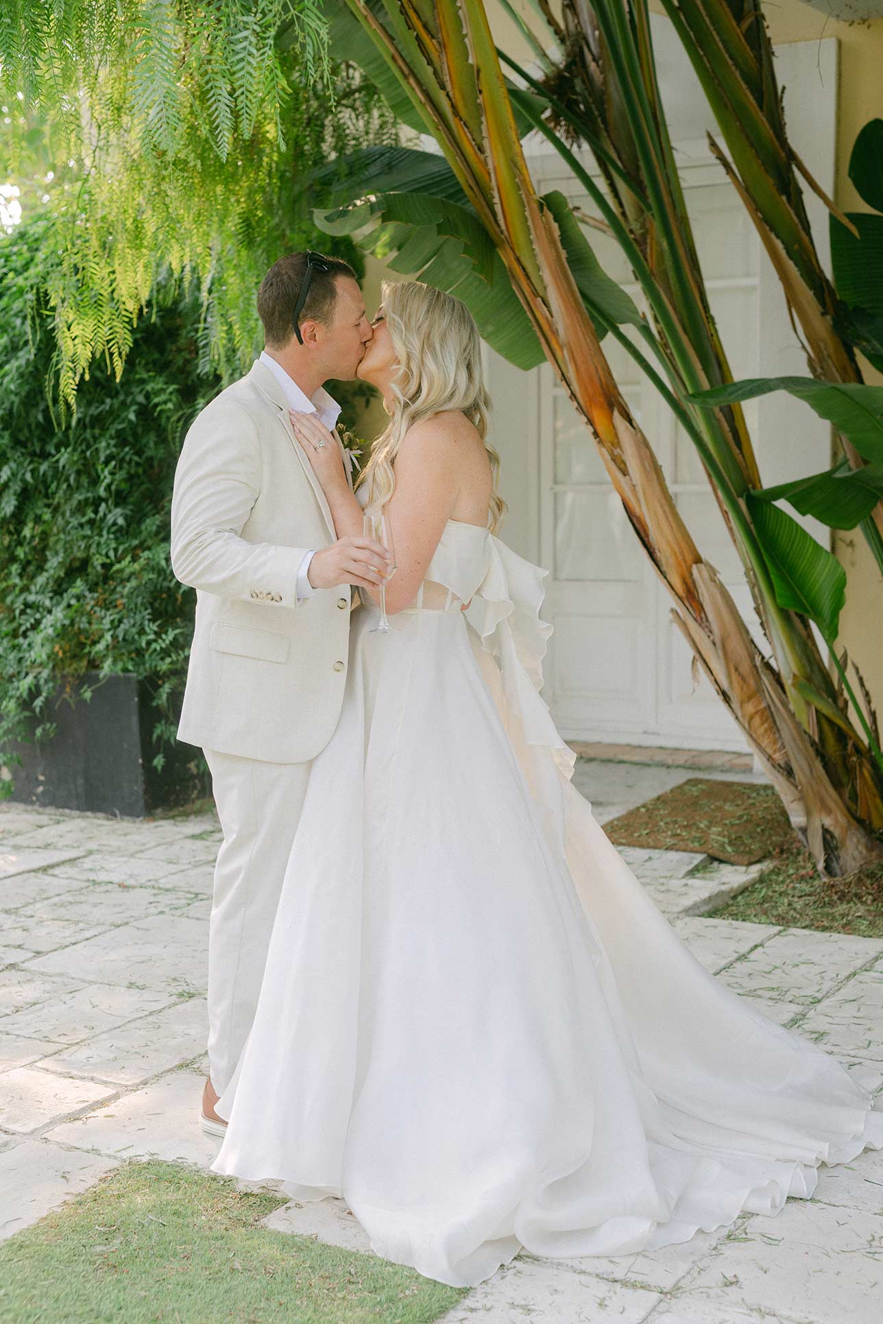 Kissing couple after the ceremony at the garden at villa wedding near Barcelona, Spain