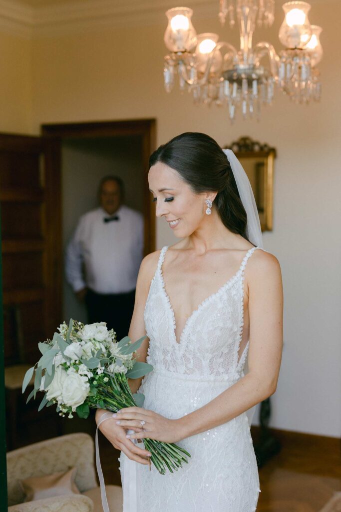 Bride holding her bouquet before a first look with her father at Hostal La Gavina in Costa Brava