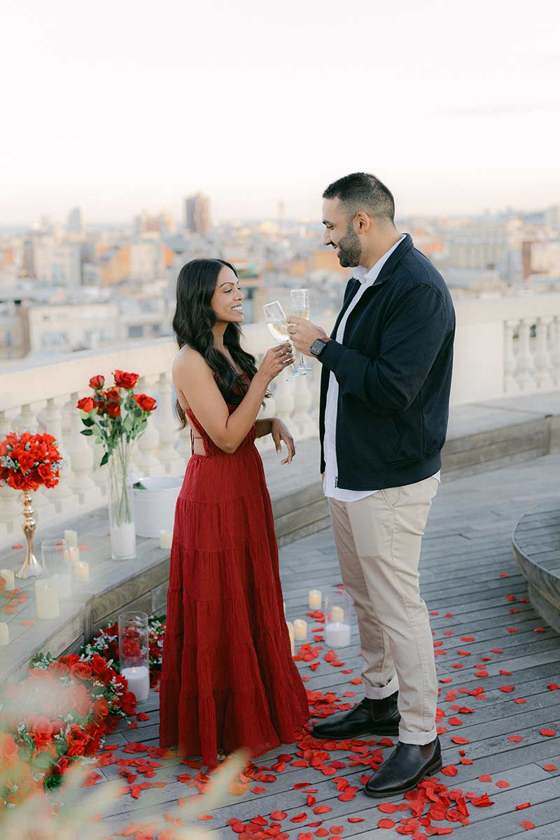 Engaged couple celebrating after a surprise proposal on a private rooftop in Barcelona