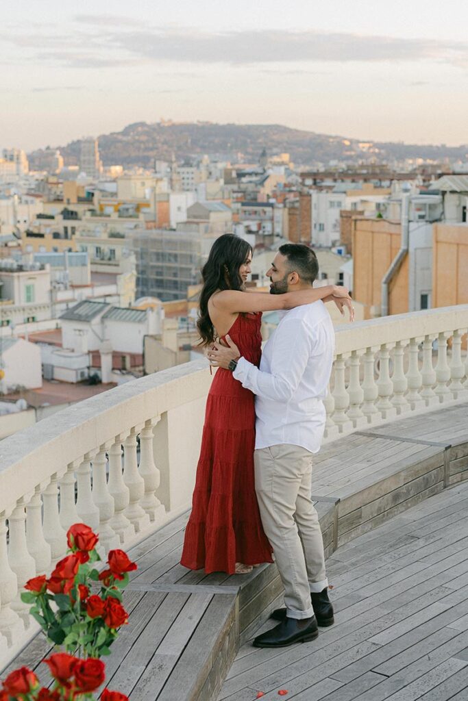Couple embracing on a private rooftop terrace during a Barcelona proposal photography session