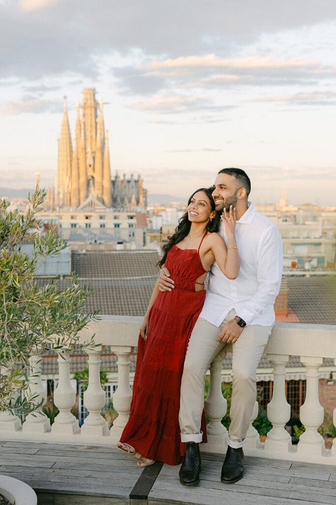 Couple toasting their engagement on a private rooftop terrace with Barcelona skyline views