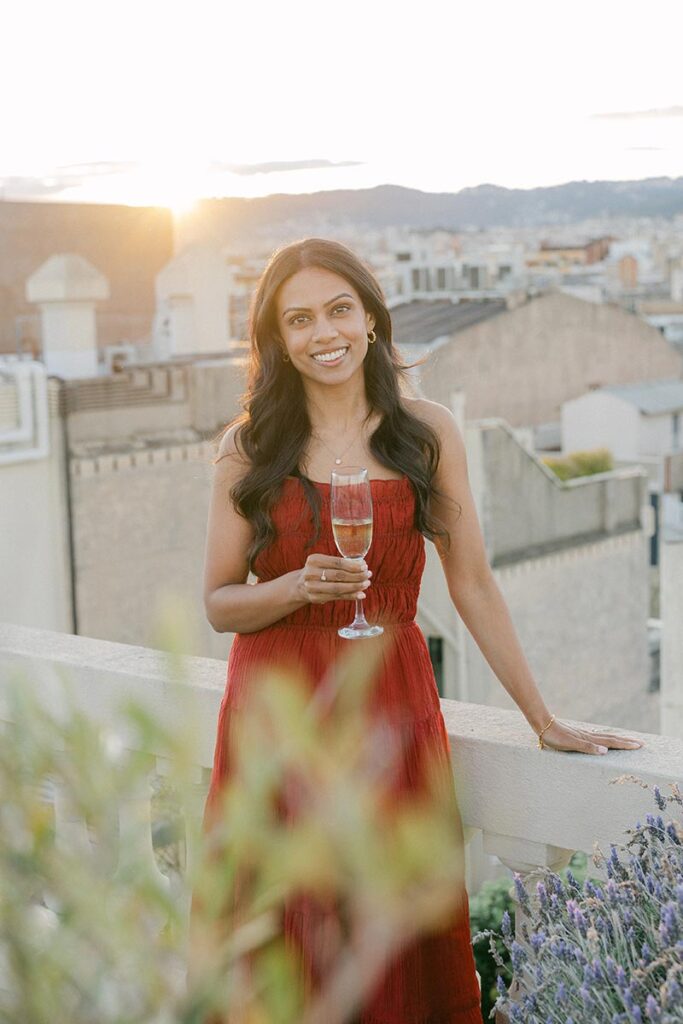 Woman celebrating her Barcelona engagement on a private rooftop terrace at sunset