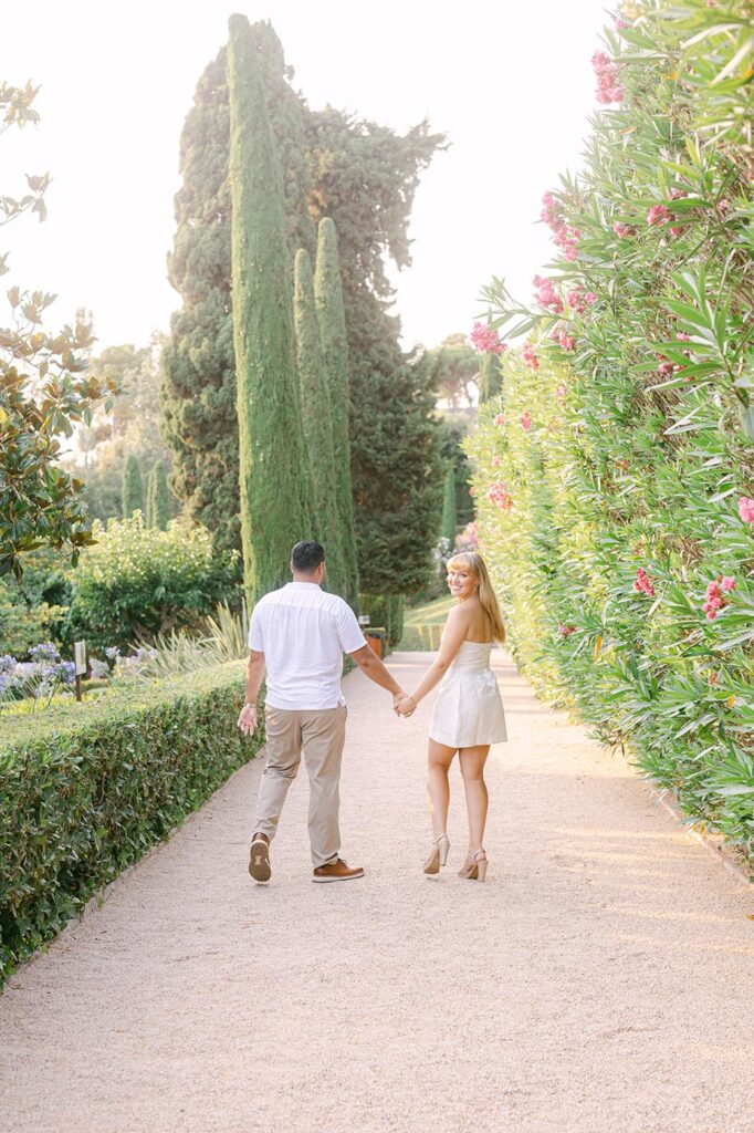 Couple walking through the Santa Clotilde architectural, symmetrical garden. Best locations for surprise proposal on the Costa Brava, Barcelona