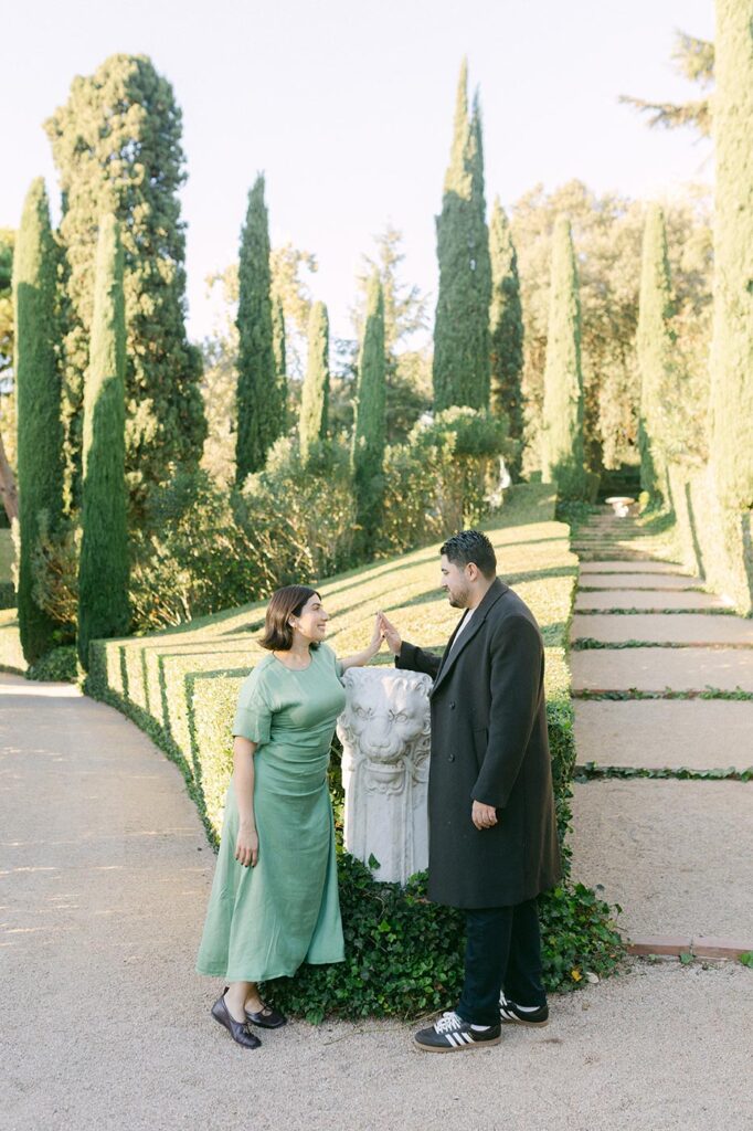 couple enjoying architecture and garden after surprise proposal on Costa Brava. Spain engagement photographer Lena Karelova