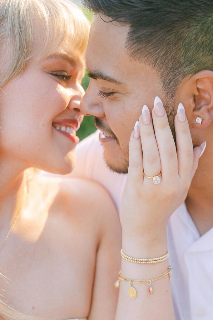 Kissing couple, woman wearing engagement ring. Best locations for surprise proposal on the Costa Brava