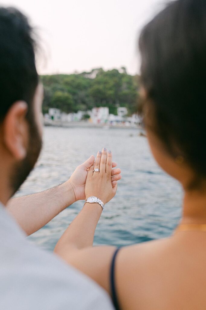 Hand in hand and engagement ring after suprise proposal on Costa Brava, Begur private boat